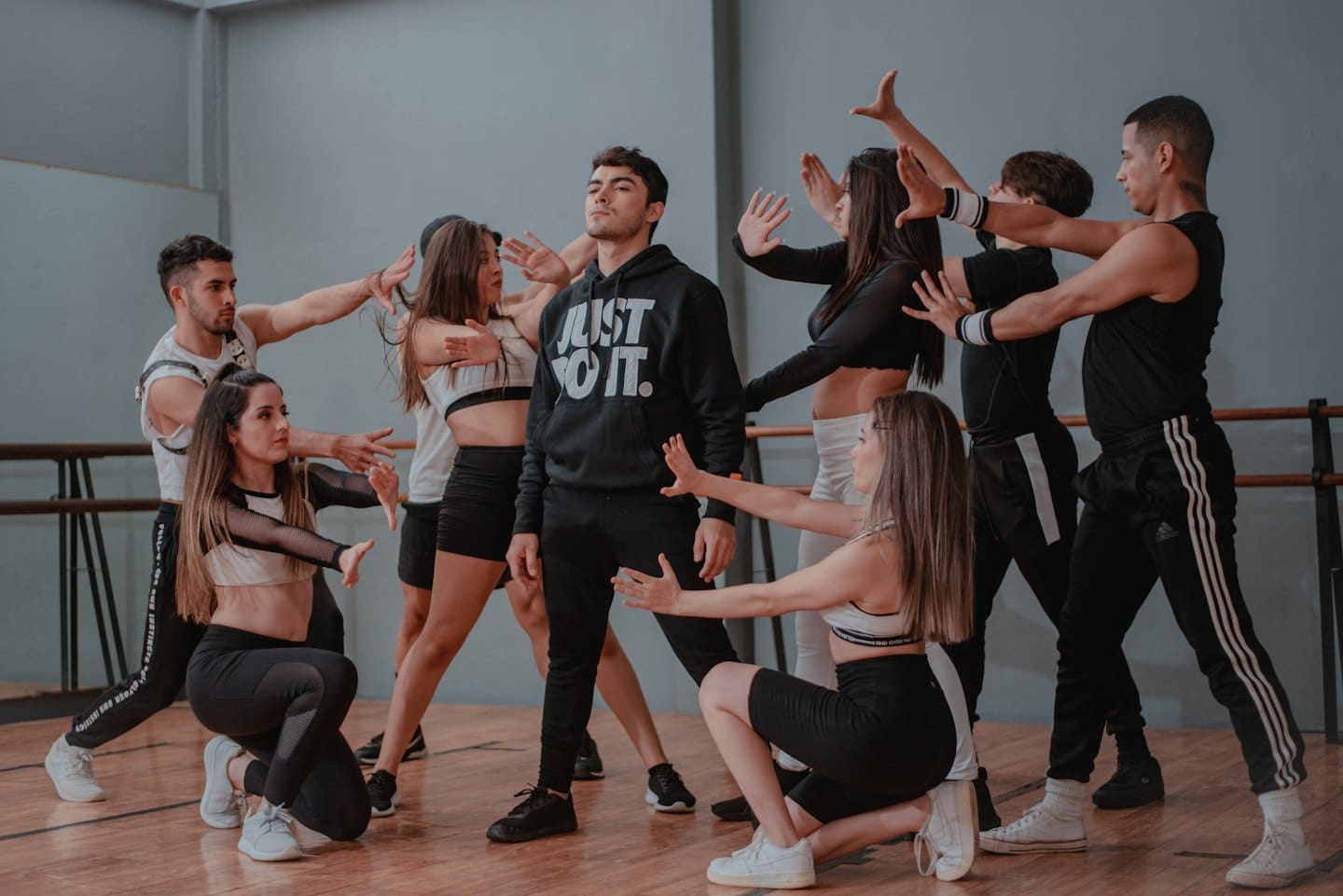 Dancers in a studio during a rehearsal with the main dancer looking up.